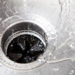 Water going down the sink into a garbage disposal
